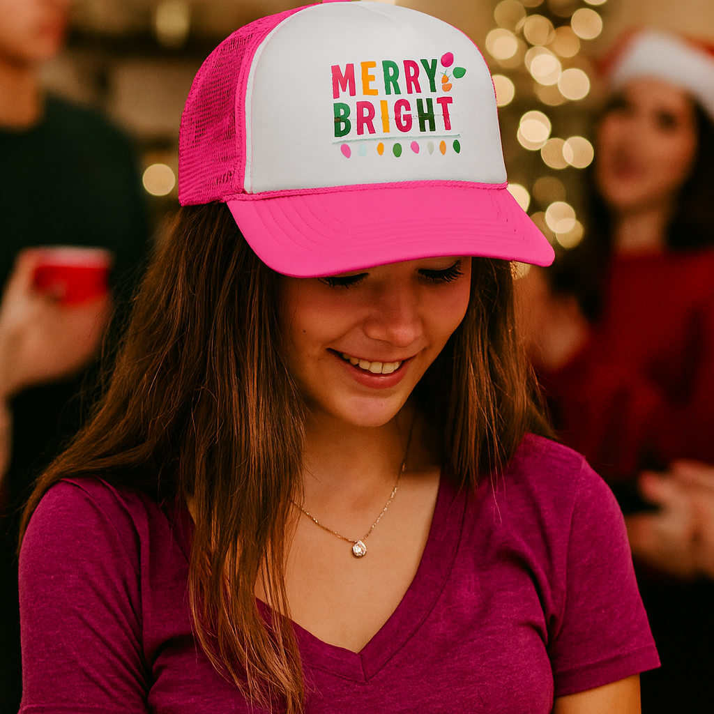 Person wearing a pink and white cap with 'Merry Bright' text, blurred festive background