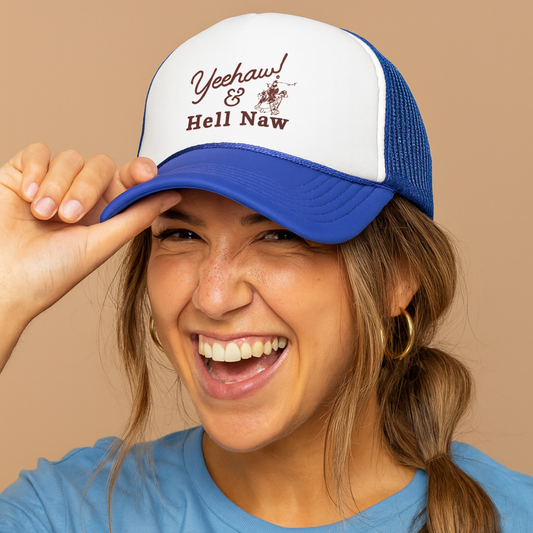Person wearing a blue and white cap with text that says heehaw & hell naw with a cowboy, smiling against a beige background